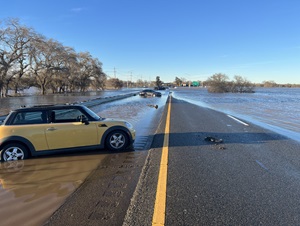 Image of flooded highway with cars stranded in the flood waters