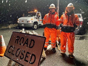 Image of Caltrans road workers on the highway during a snow storm