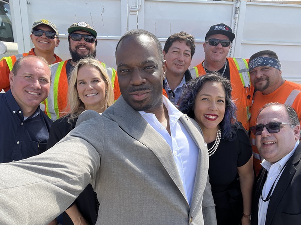 Secretary Toks pictured in front of a group of Caltrans office staff and road crew members